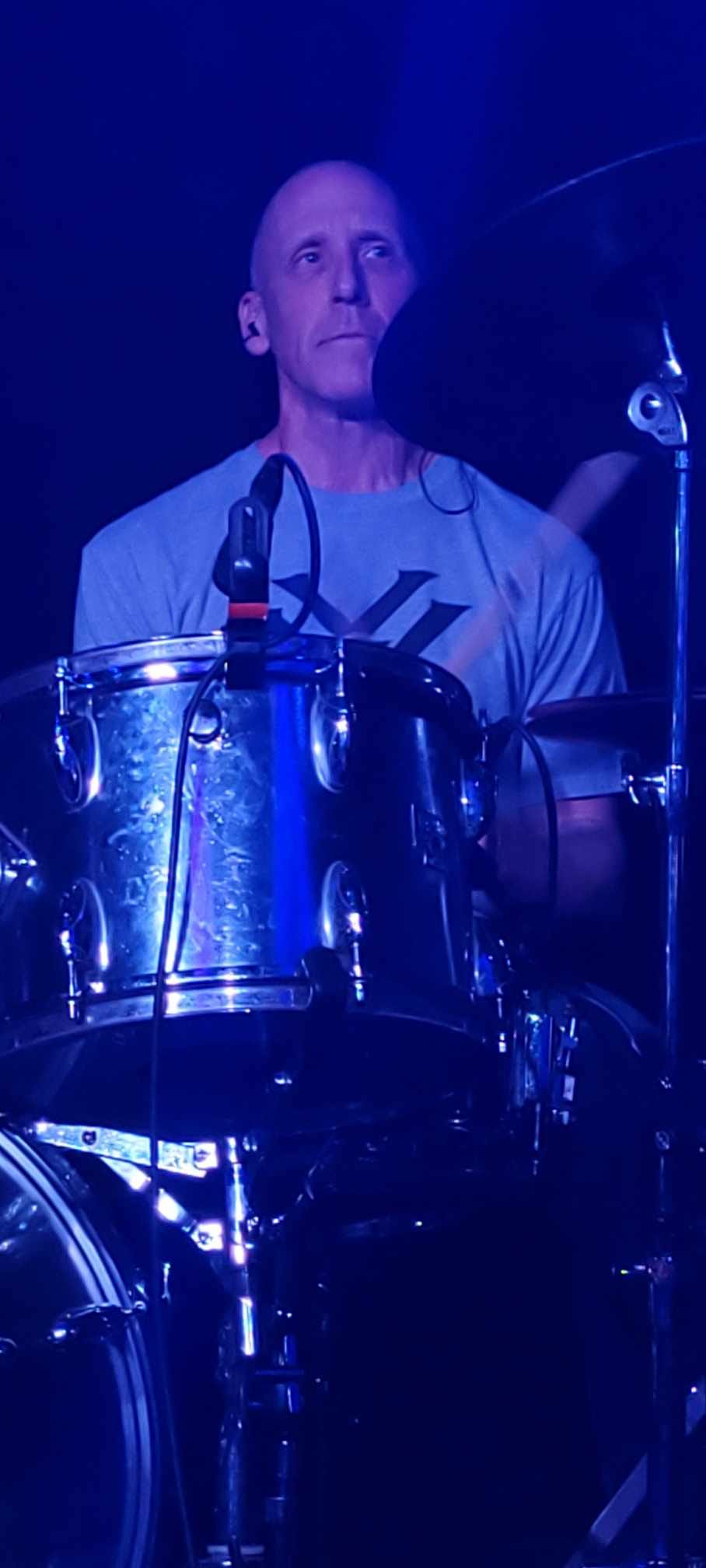 Greg from River Cats band performing energetically at Blue Martini Kingston