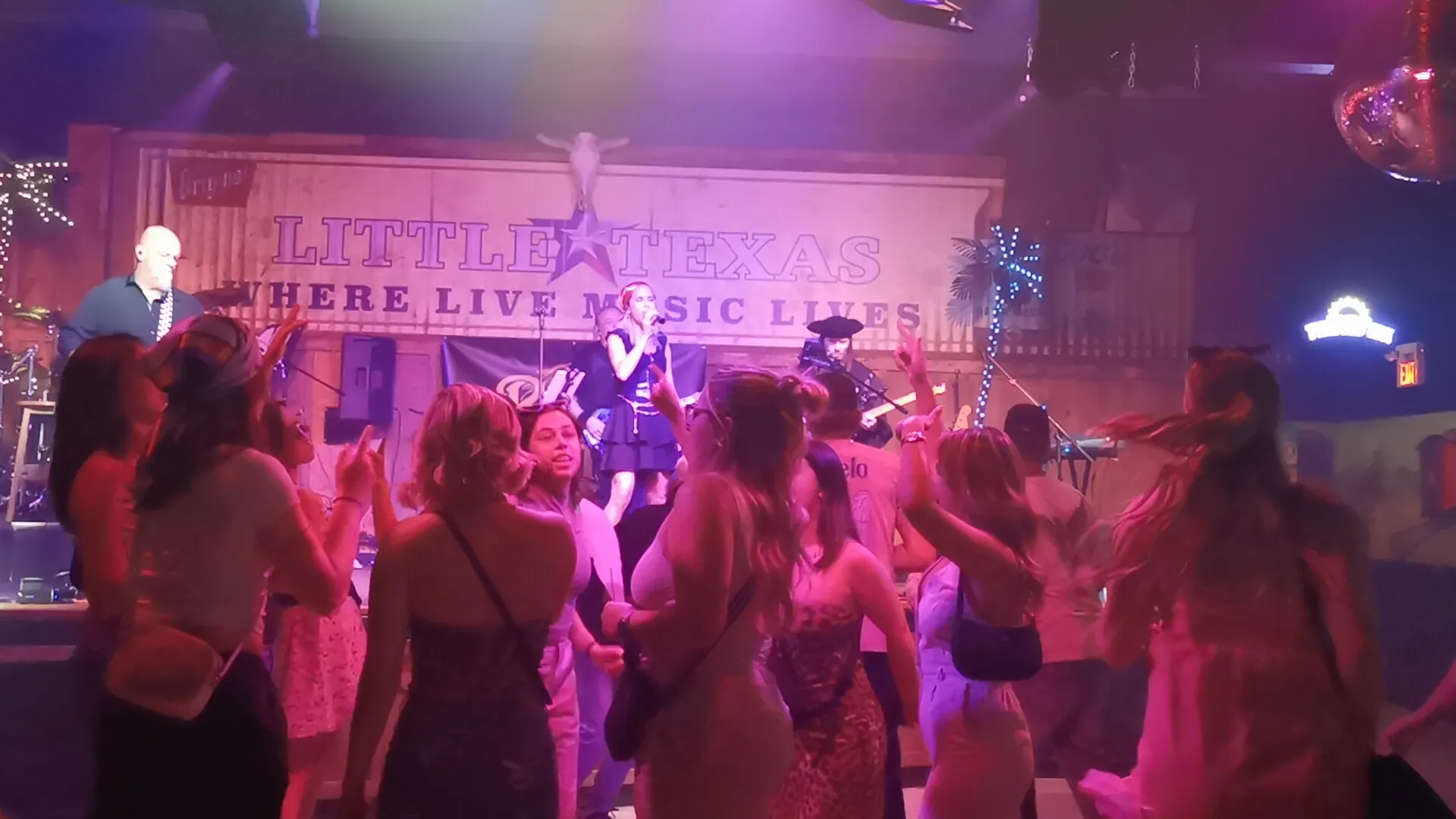 River Cats live on stage at Little Texas for Caribbean Nights! with vibrant costumes and dancing crowd