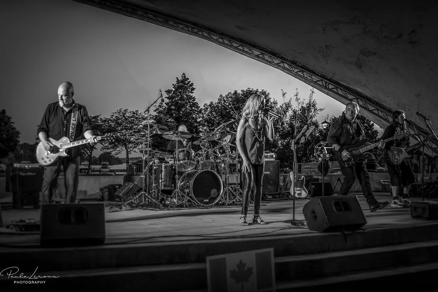 River Cats black and white performance photo at Joel Stone Park Music Series Gananoque with waterfront stage setting