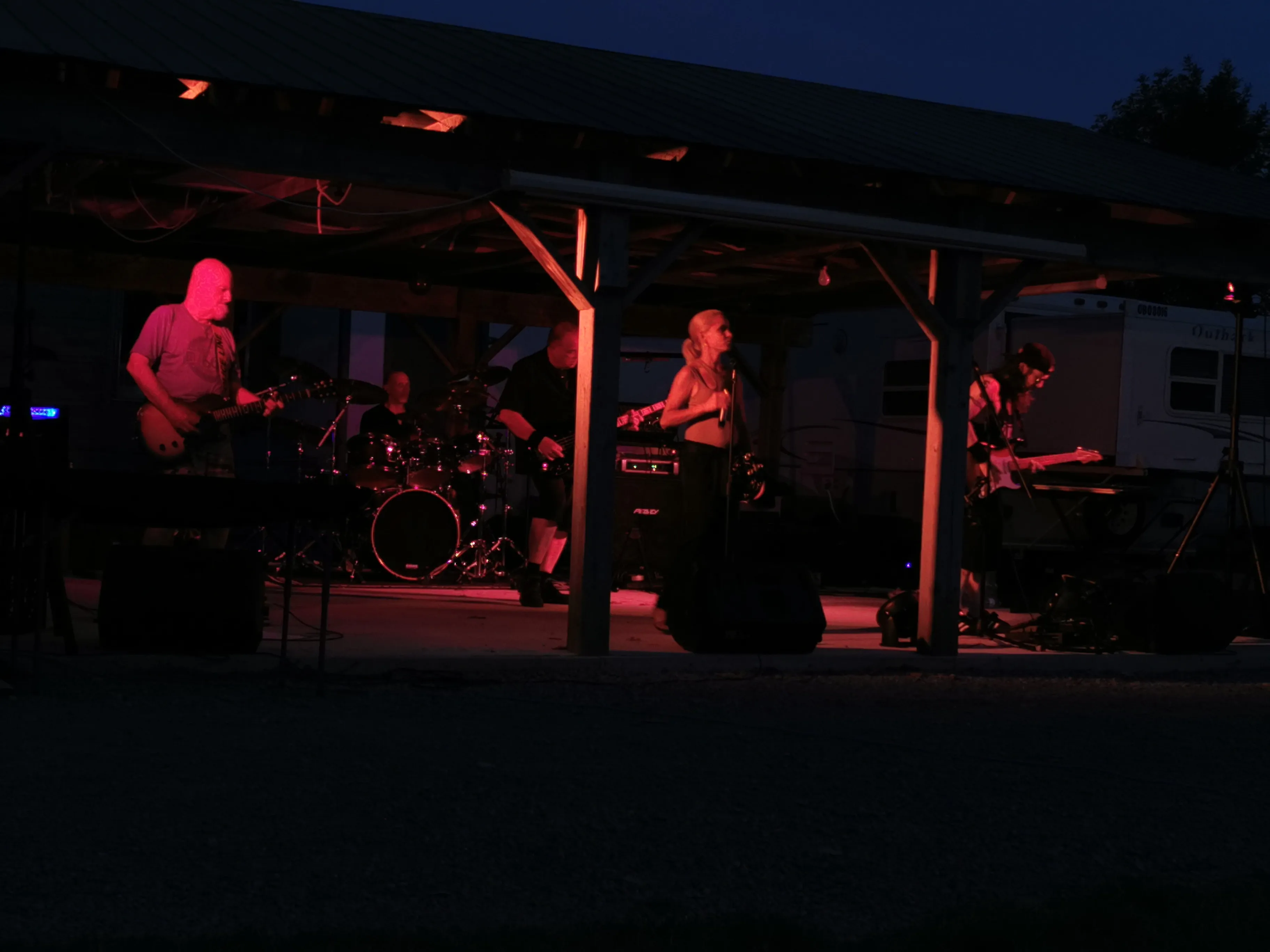 River Cats outdoor waterfront performance at Ray's Cottages with scenic lake view and evening atmosphere