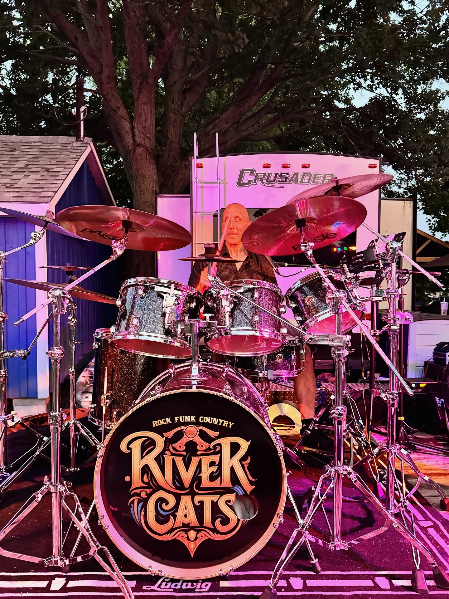 River Cats band performing at Ray's Cottages Bloomfield with families and children dancing to live music